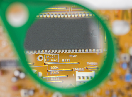 printed circuit board and magnifying glassの写真素材