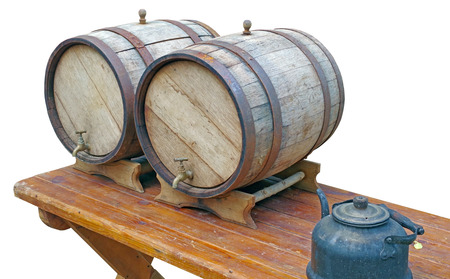 Old oak barrels on a wooden table on white backgroundの写真素材
