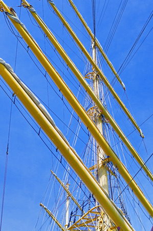 Masts and rigging of a sailing ship against blue sky
