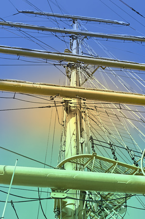 Masts and rigging of a sailing ship against sky