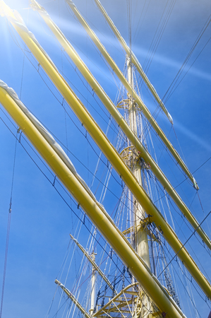 Masts and rigging of a sailing ship against blue skyの写真素材