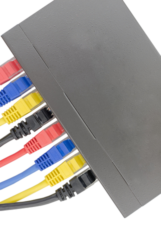 Multicolored network cables connected to router on a white background