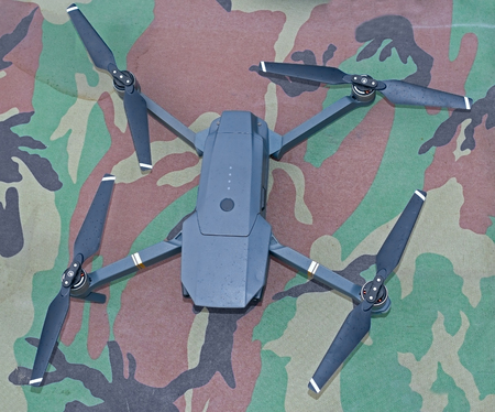 drone quadcopter on the background of camouflage fabric