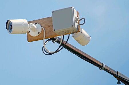 the two CCTV cameras against the blue sky