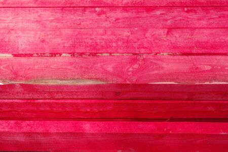 Firewood red logs stacked as abstract natural patternの写真素材