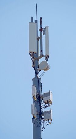 Tower with aerials of cellular on a background blue sky