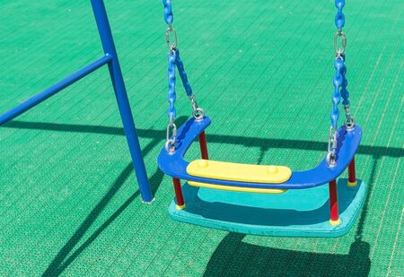 swing on chain hanging on Children's playgroundの写真素材