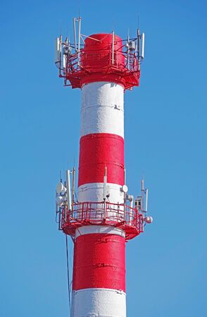 Tower with aerials of cellular on a background blue skyの写真素材