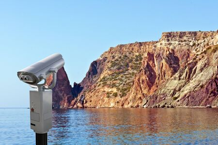 Coin-operated binoculars looking out over Mountains and the seaの写真素材