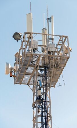 Tower with aerials of cellular on a background blue sky