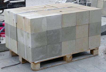 Tile blocks on pallets lie next to each other on the streetの写真素材