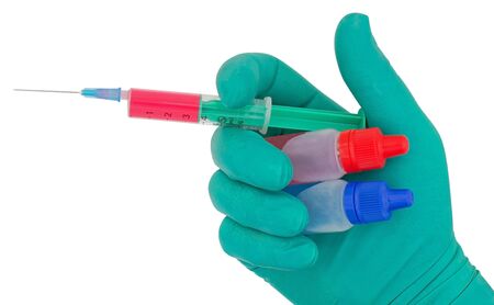 Syringe in hand medical glove medicine isolated on white backgroundの写真素材