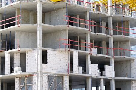 The facade of modern residential building under construction. The construction of modern apartment...
