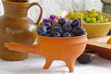 the Fruit plums blue on the table in a plateの写真素材