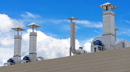 large industrial shiny metal pipes against the blue sky