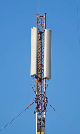 Tower with aerials of cellular on a background blue sky