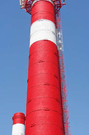 Tower with aerials of cellular on a background blue sky