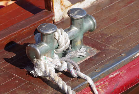 Bollard with rope abovedeck old ship