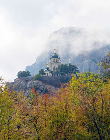 landscape with a old Church in the mountains in the fog
