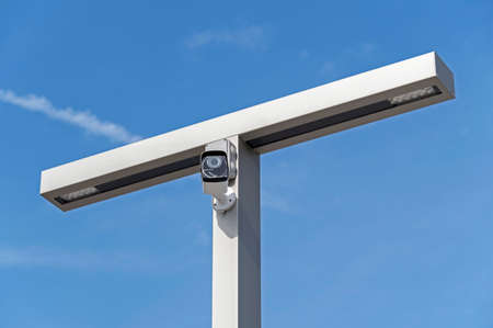 IP security camera and led Street lantern mounted on post against the blue sky