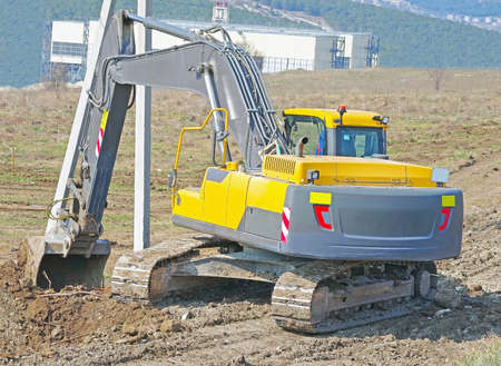 modern yellow excavator machines on the construction site