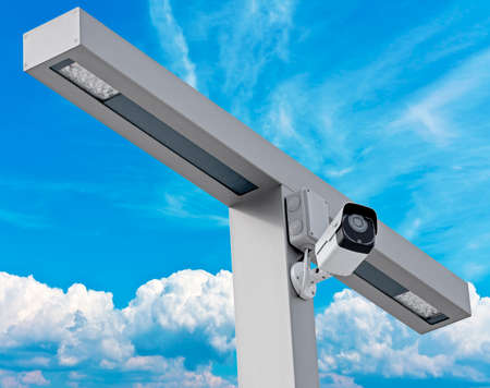 IP security camera and led Street lantern mounted on post against the blue sky