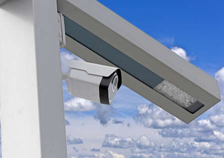 IP security camera and led Street lantern mounted on post against the blue sky