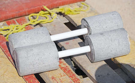 Authentic homemade sports dumbbells made of concrete outdoorの写真素材