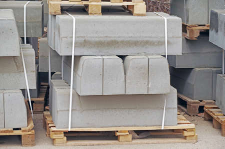 The pallet with a stack of concrete curbstone on construction sitesの写真素材