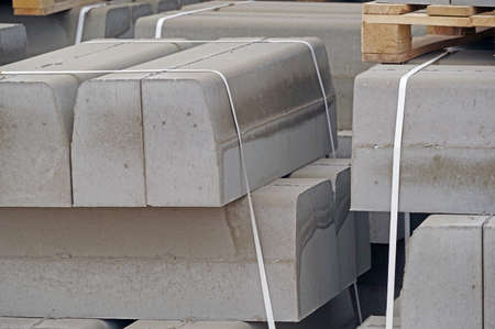 The pallet with a stack of concrete curbstone on construction sitesの写真素材