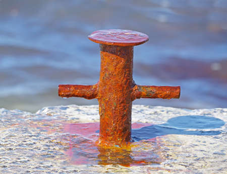 big old rusty Bollard on moorage