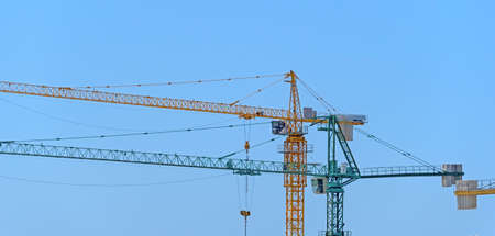 part of yellow construction crane at blue sky backgroundの写真素材