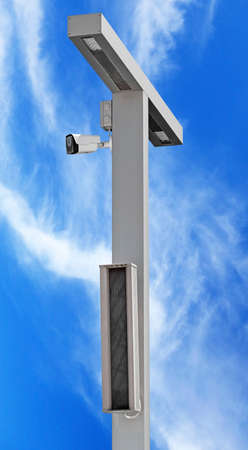 IP security camera and led Street lantern mounted on post against the blue sky