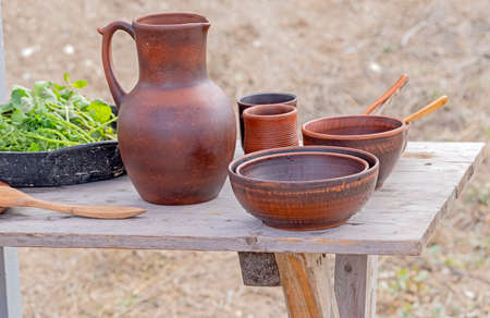 Ceramic dishes on a wooden table at the exhibition