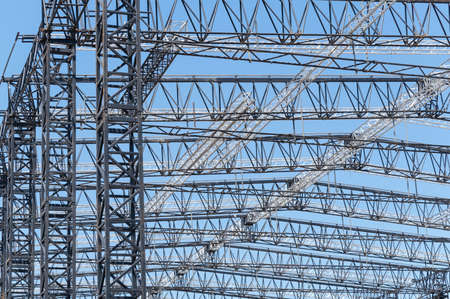 steel structure workshop is under construction on a background blue skyの写真素材