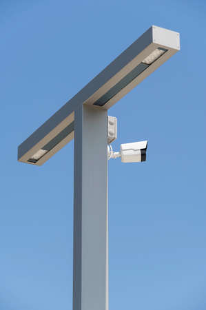 IP security camera and led Street lantern mounted on post against the blue sky