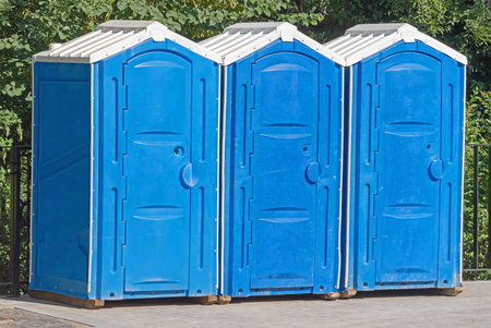 three blue biotoilet in the city parkの写真素材