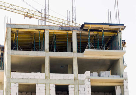 The facade of modern residential building under construction. The construction of modern apartment...