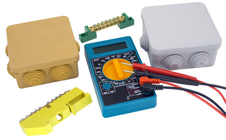 Electricity terminal strips, cutting box and digital multimeter on a white background