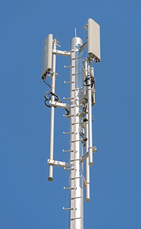 Tower with aerials of cellular on a background blue sky