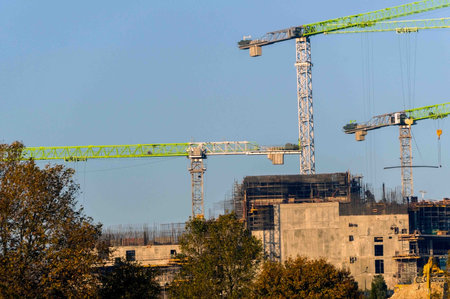 Building crane and building under construction against blue sky