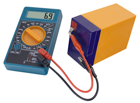 Testing an acid rechargeable battery with a measuring instrument isolated on white background