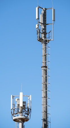 Tower with aerials of cellular on a background mountains and blue sky