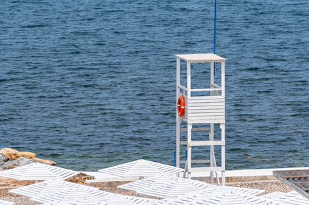 Sea beach with sand and long row of wooden umbrellasの写真素材
