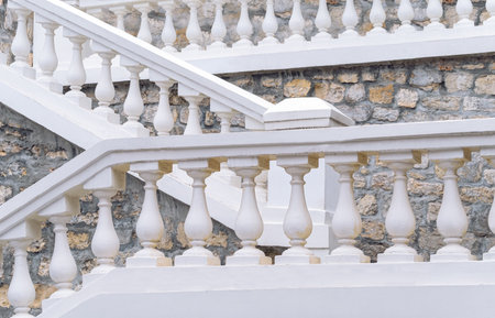 A staircase with a beautiful white stone railing