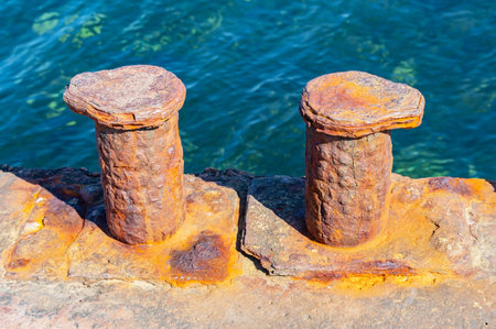 big old rusty bollard on moorage