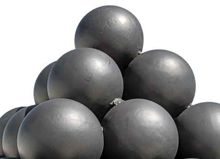 A pyramid of black solid shots on a white backgroundの写真素材