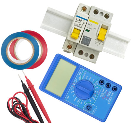 Electrical modular circuit breaker, insulating tape and digital multimeter on a white background