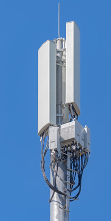 Tower with aerials of cellular on a background blue sky