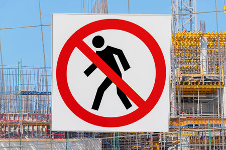 the no entry sign is mounted on a wire fence on a construction siteの写真素材